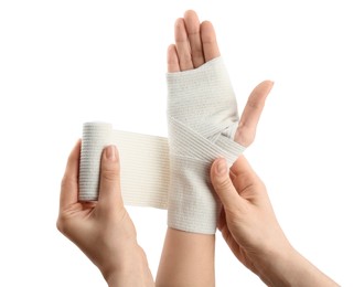 Photo of Woman applying bandage onto patient's hand on white background, closeup