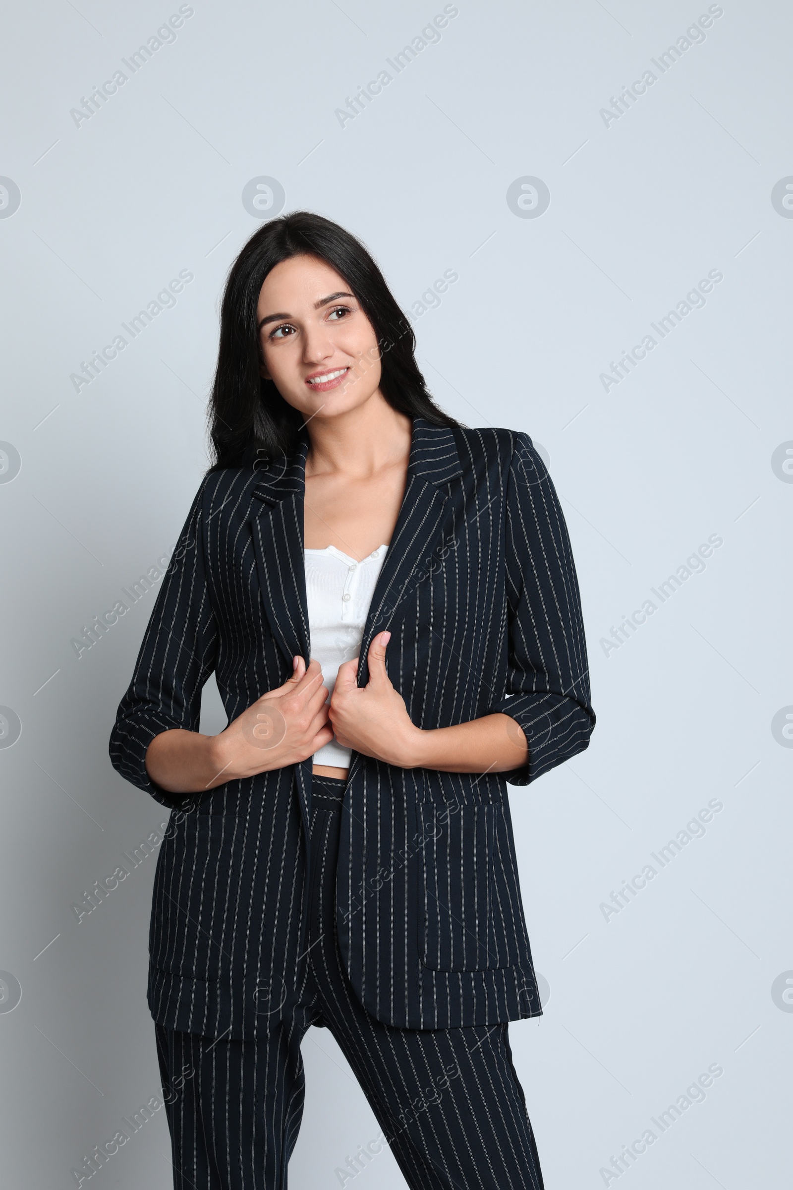 Photo of Beautiful woman in formal suit on white background. Business attire