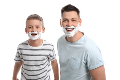 Photo of Happy dad and son with shaving foam on faces, white background