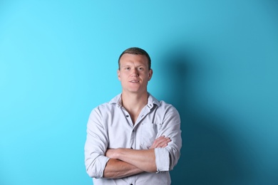 Photo of Handsome confident young man on color background