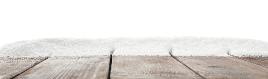 Photo of Artificial snow on wooden table against white background. Christmas decor