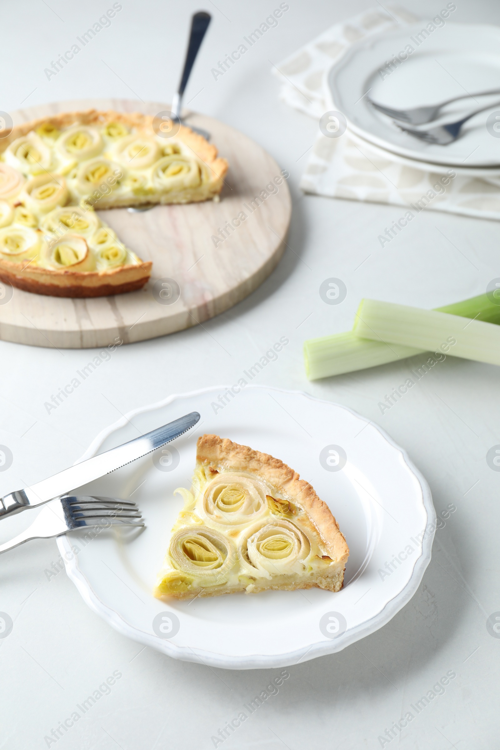 Photo of Tasty leek pie served on white table