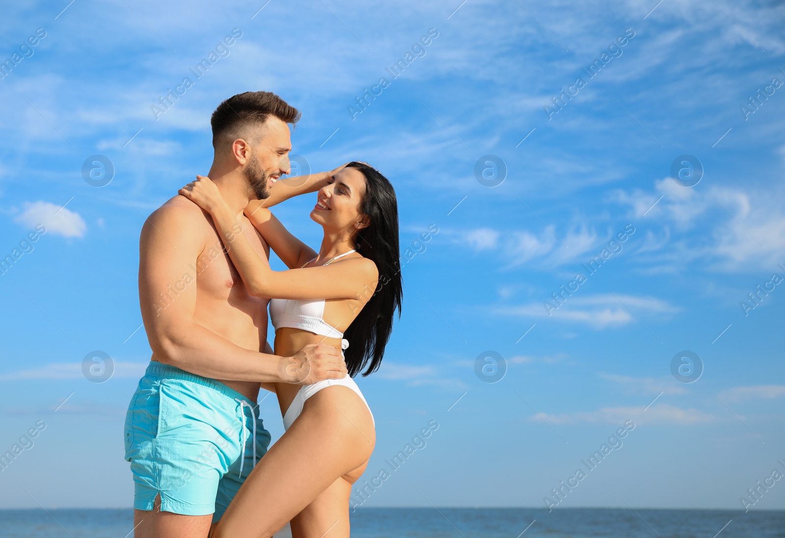 Photo of Happy young couple at beach on sunny day