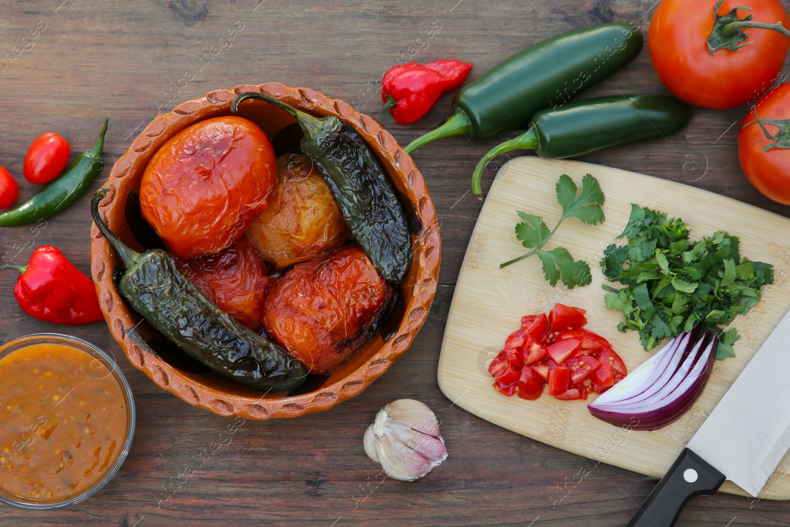 Photo of Tasty salsa sauce and ingredients on wooden table, flat lay