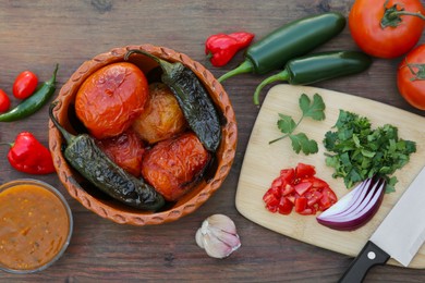 Photo of Tasty salsa sauce and ingredients on wooden table, flat lay