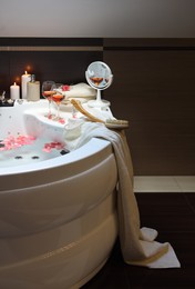 Bathtub with glasses of wine and candles indoors. Romantic atmosphere