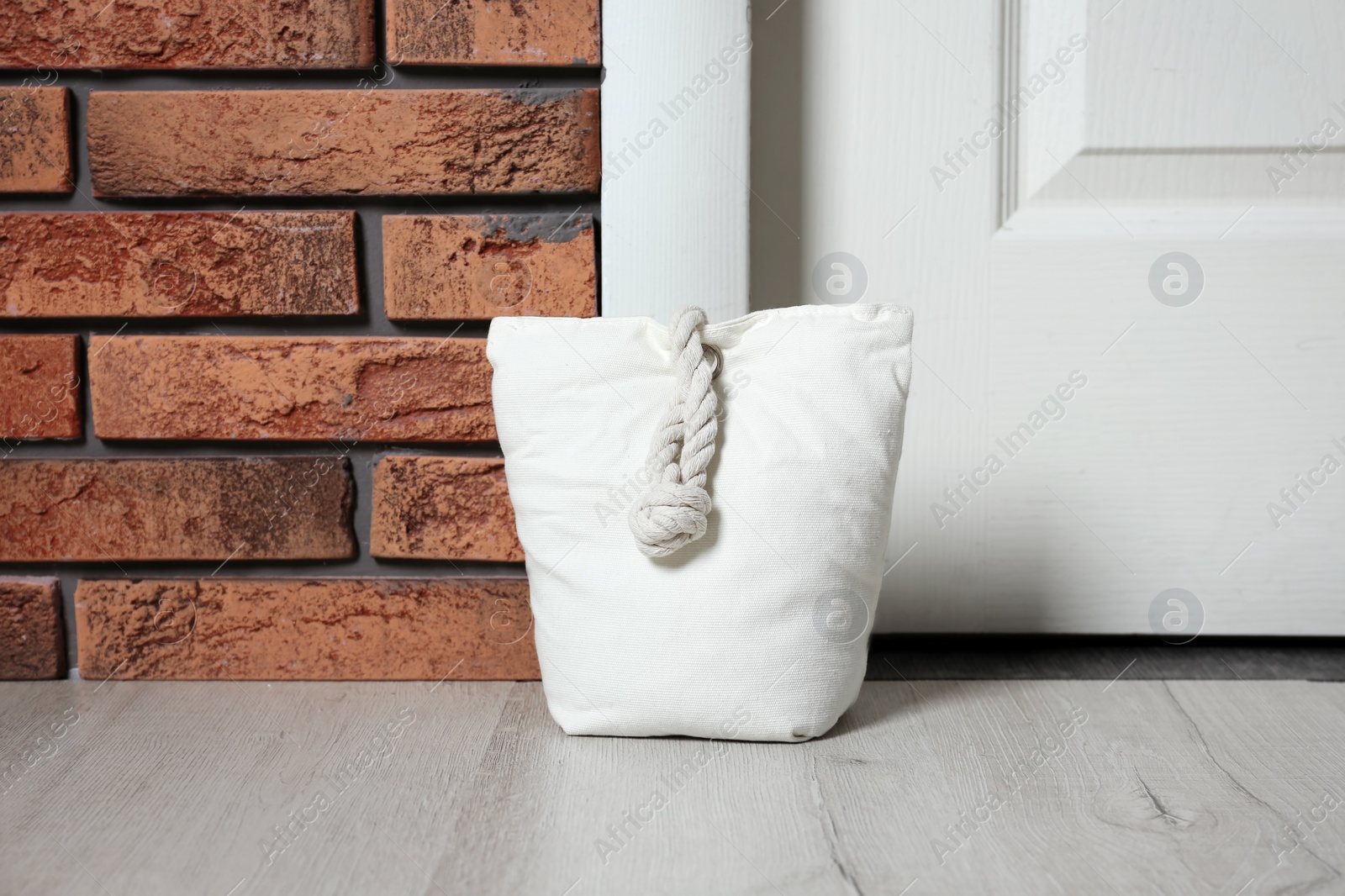 Stuffed bag near white door at home Photo of Stuffed bag near white door at home