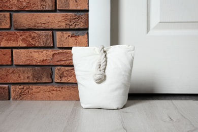 Photo of Stuffed bag near white door at home