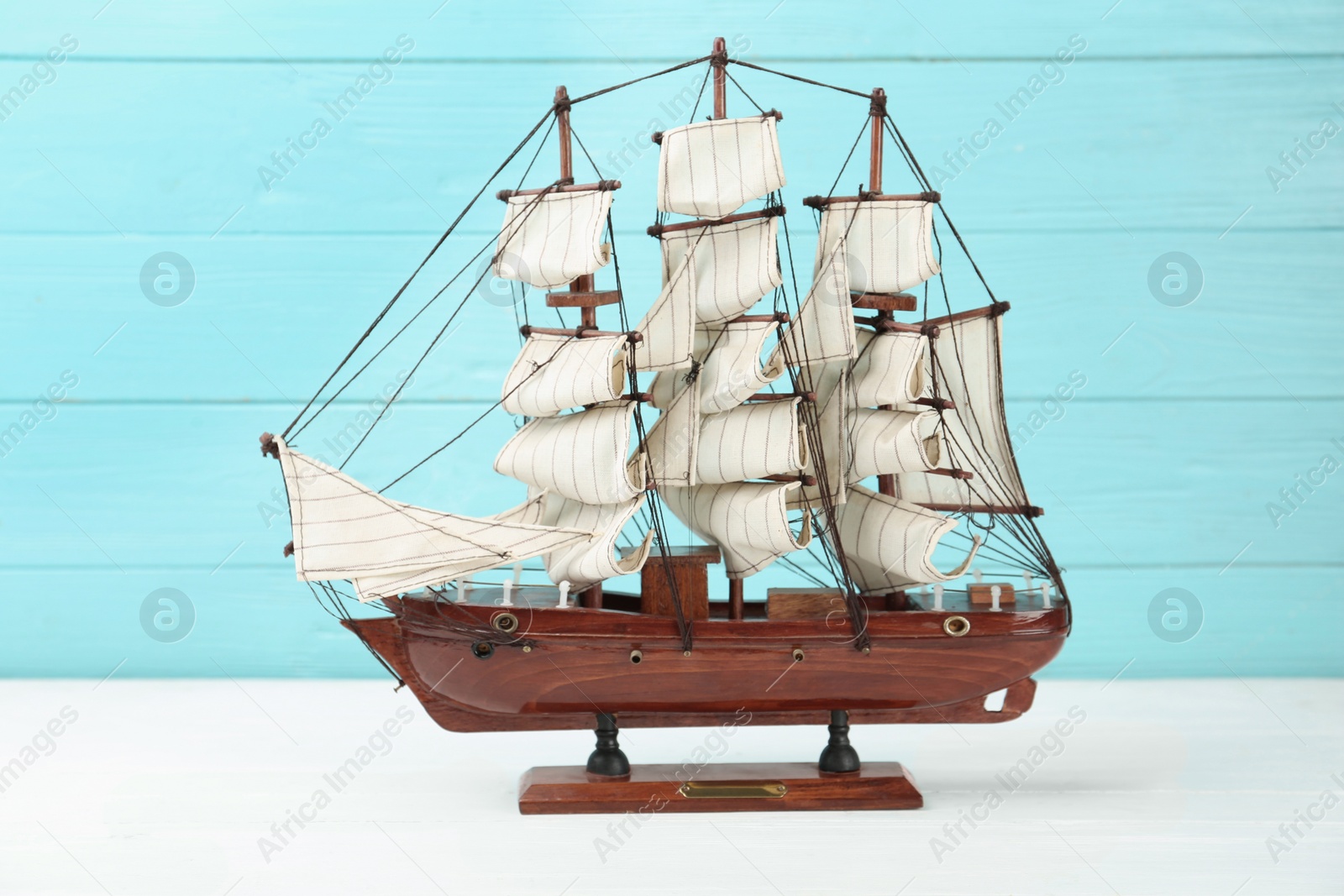 Photo of Beautiful ship model on white wooden table