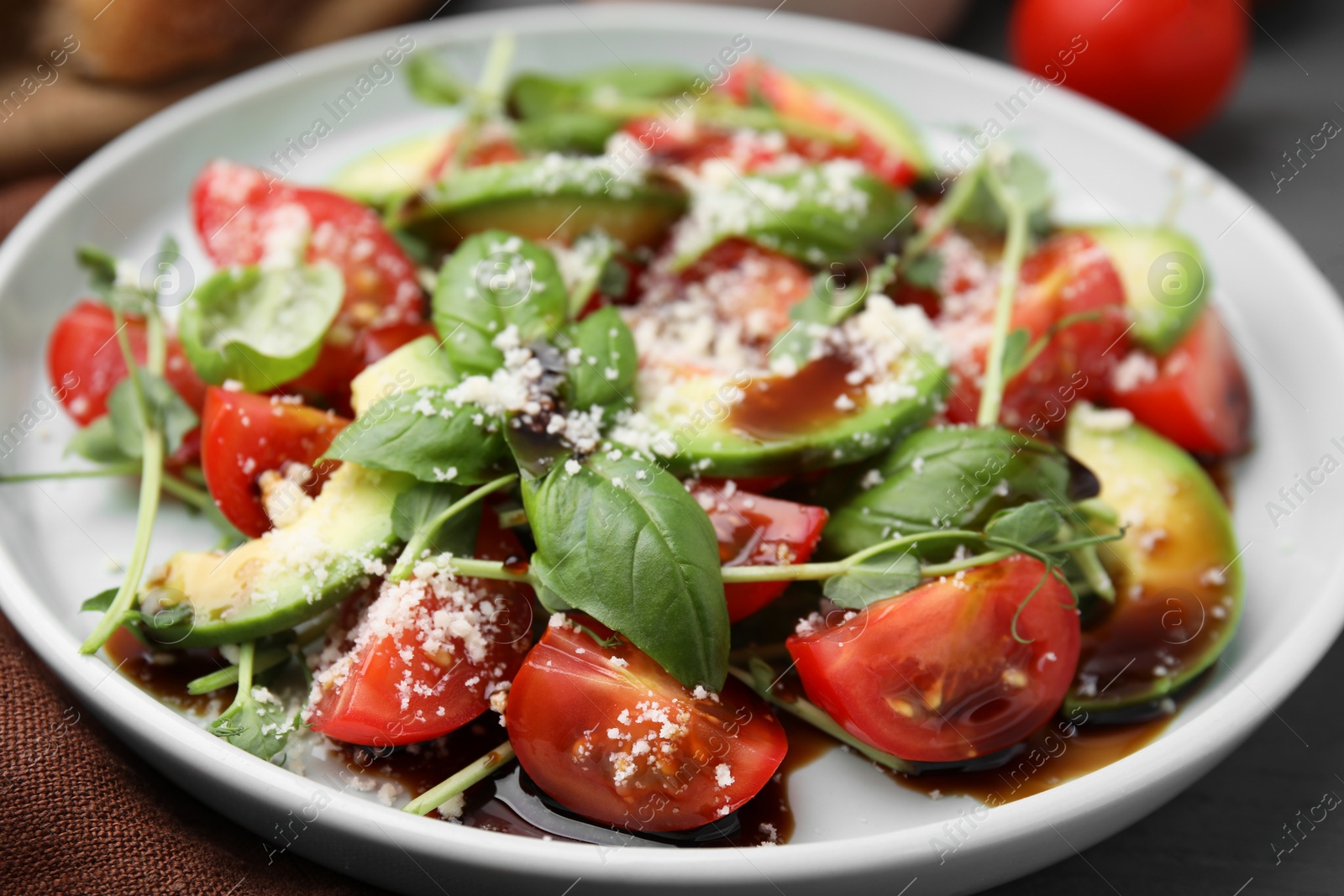 Photo of Tasty salad with balsamic vinegar on table, closeup