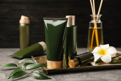 Composition with cosmetic products on grey table