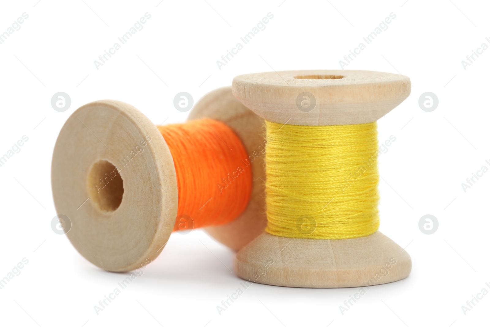 Photo of Different colorful sewing threads on white background