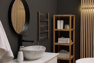 Stylish bathroom interior with heated towel rail and modern furniture