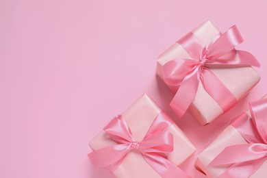 Photo of Beautiful gift boxes on pink background, flat lay. Space for text