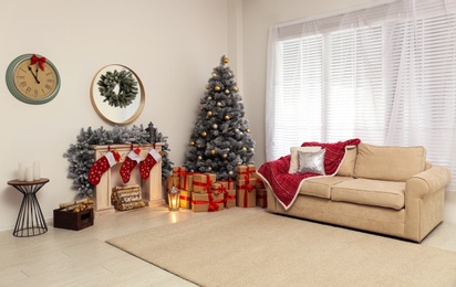 Stylish Christmas interior with decorated fir tree and fireplace