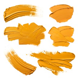 Orange oil paint strokes isolated on white, top view