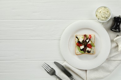 Photo of Flat lay composition with delicious anchovy sandwich on white wooden table. Space for text