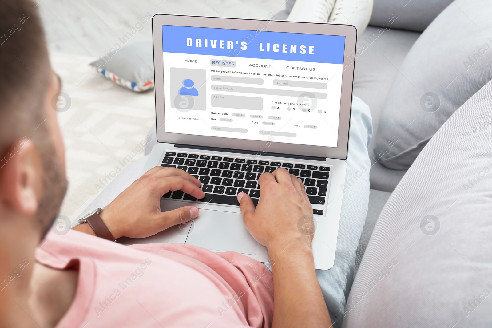 Image of Man filling in driver's license form online on website using laptop, closeup