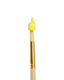 Photo of Brush with yellow paint on white background