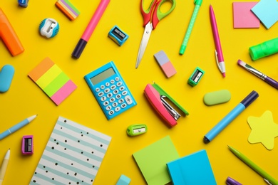 Photo of School stationery on yellow background, flat lay. Back to school