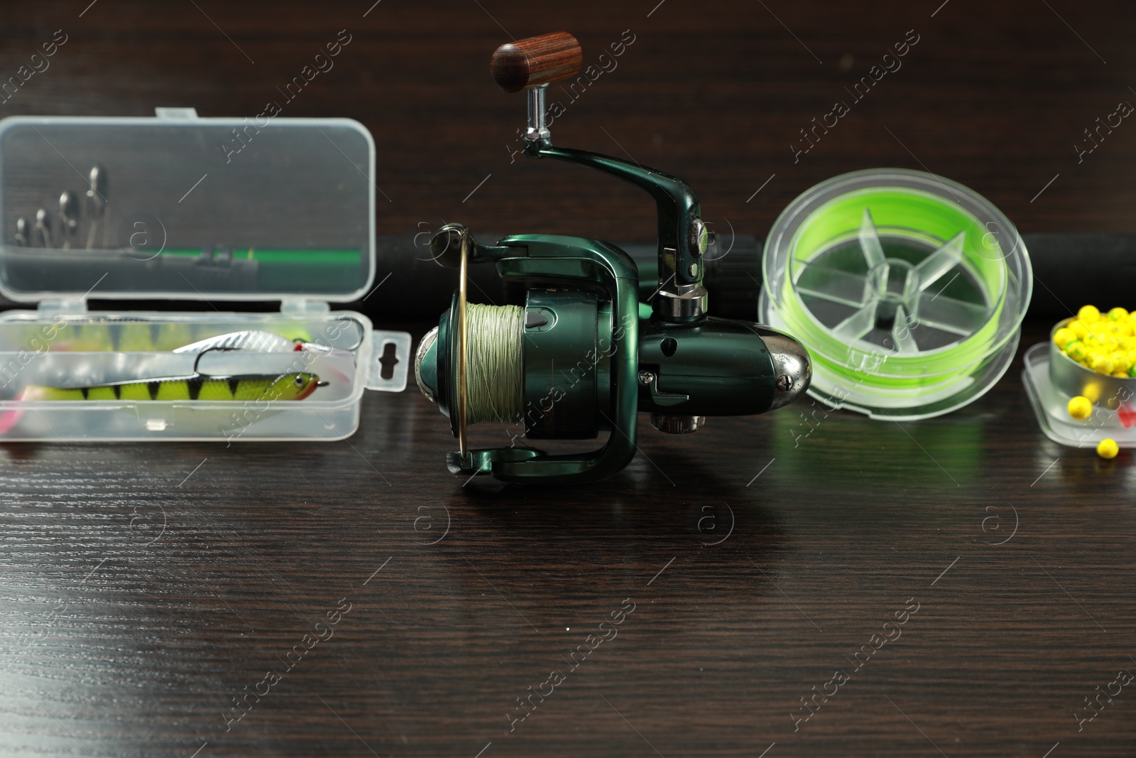 Photo of Fishing tackle on dark wooden background, closeup