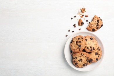 Flat lay composition with chocolate cookies and space for text on light background