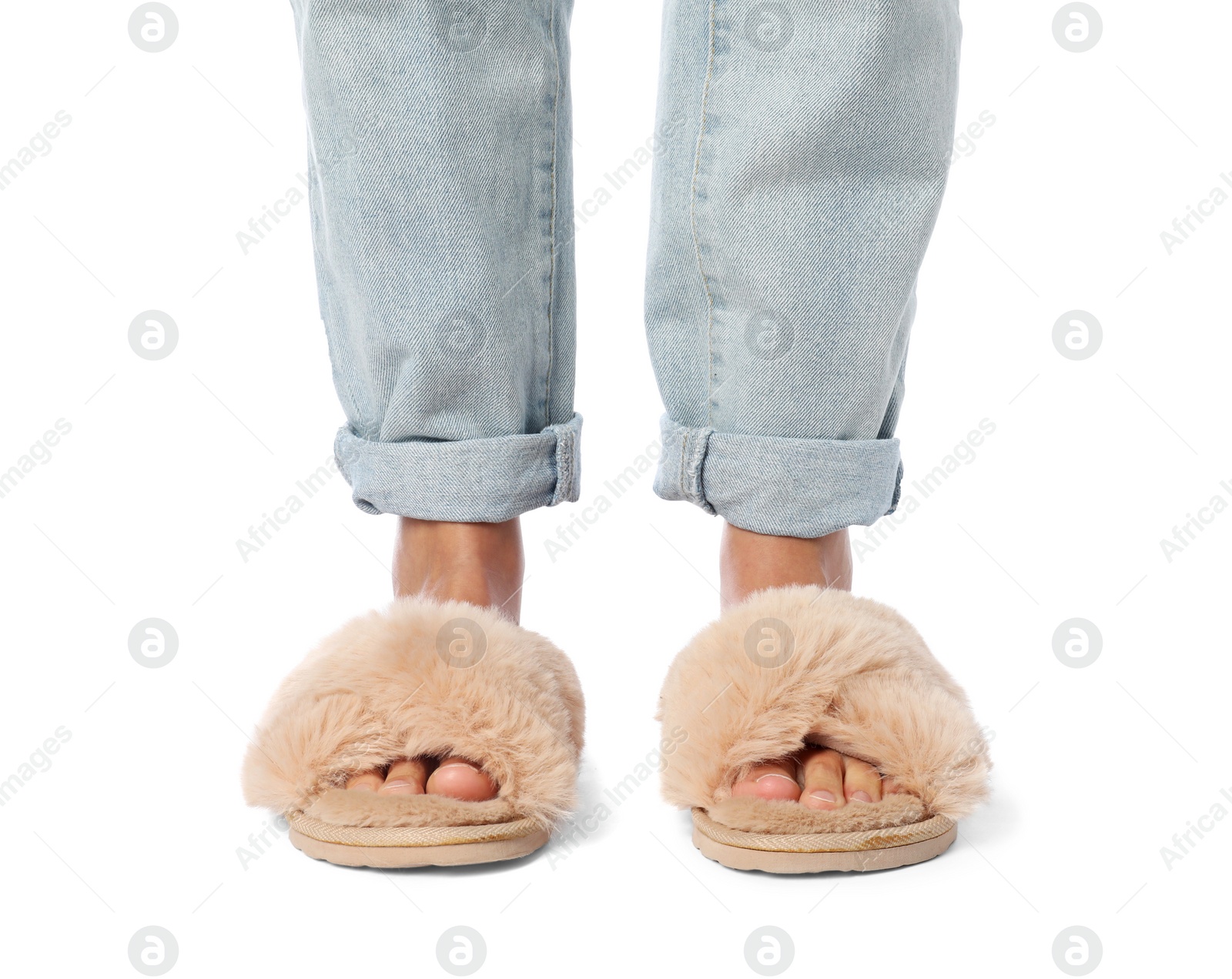 Photo of Woman in beige fluffy slippers on white background, closeup