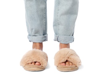 Woman in beige fluffy slippers on white background, closeup