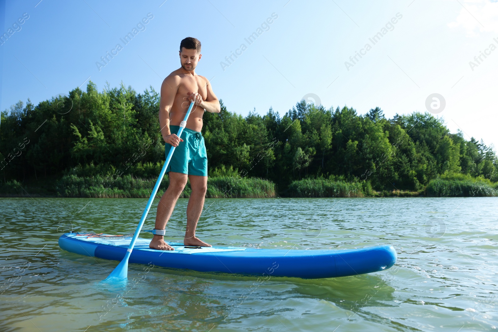 Photo of Man paddle boarding on SUP board in river