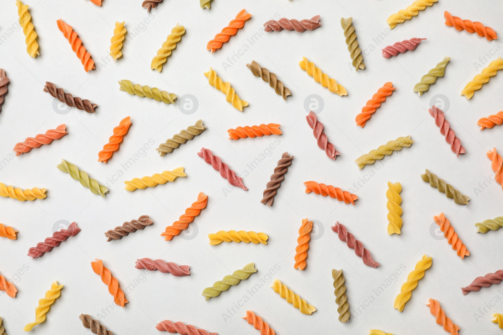 Photo of Flat lay composition with raw pasta on white background