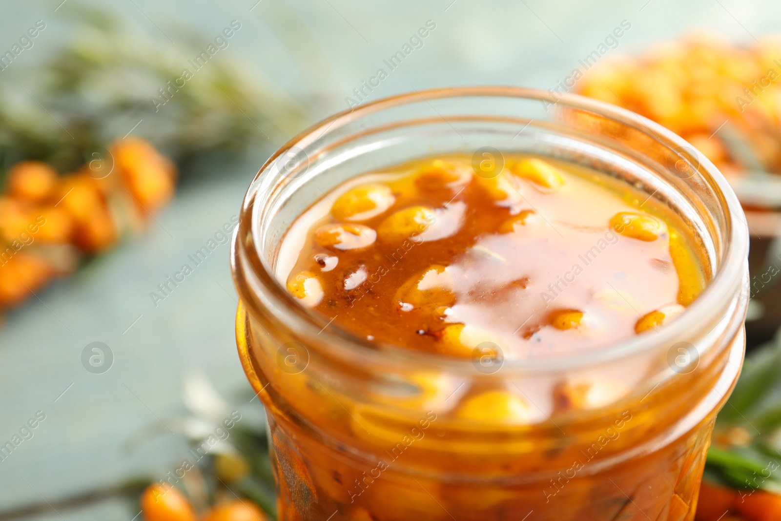 Photo of Delicious sea buckthorn jam in jar, closeup