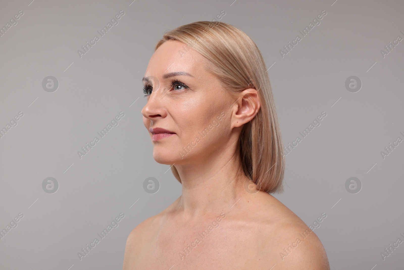 Photo of Beautiful woman with healthy skin on grey background