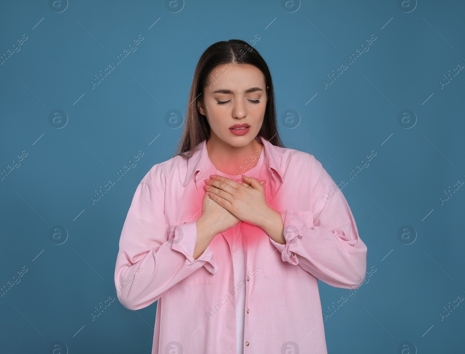 Image of Young woman suffering from cold on blue background