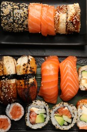 Photo of Delicious sushi rolls on black table, flat lay