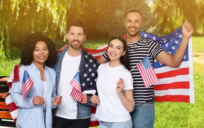 Image of 4th of July - Independence day of America. Happy friends with national flags of United States having picnic in park