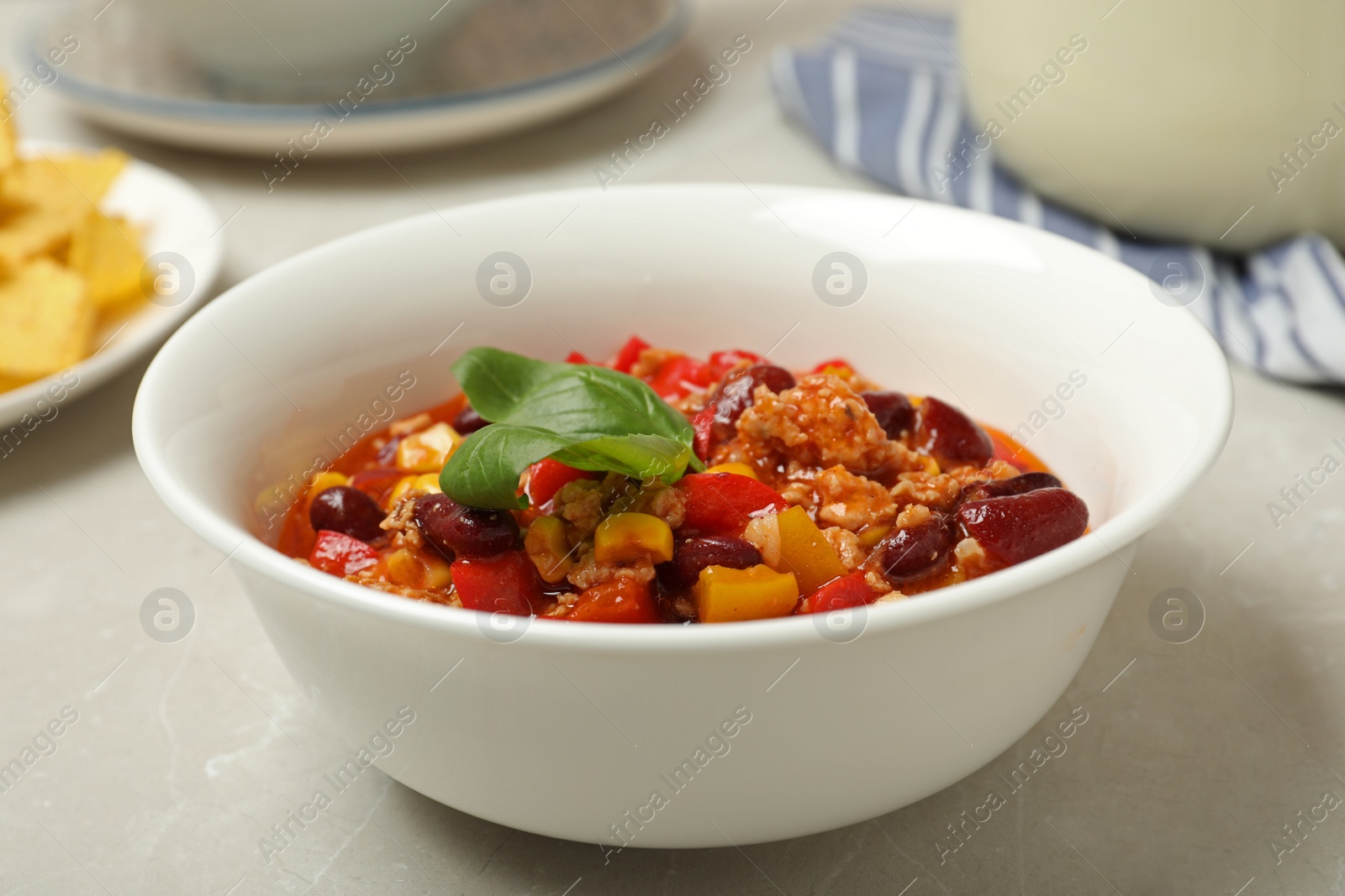 Photo of Bowl with chili con carne on table