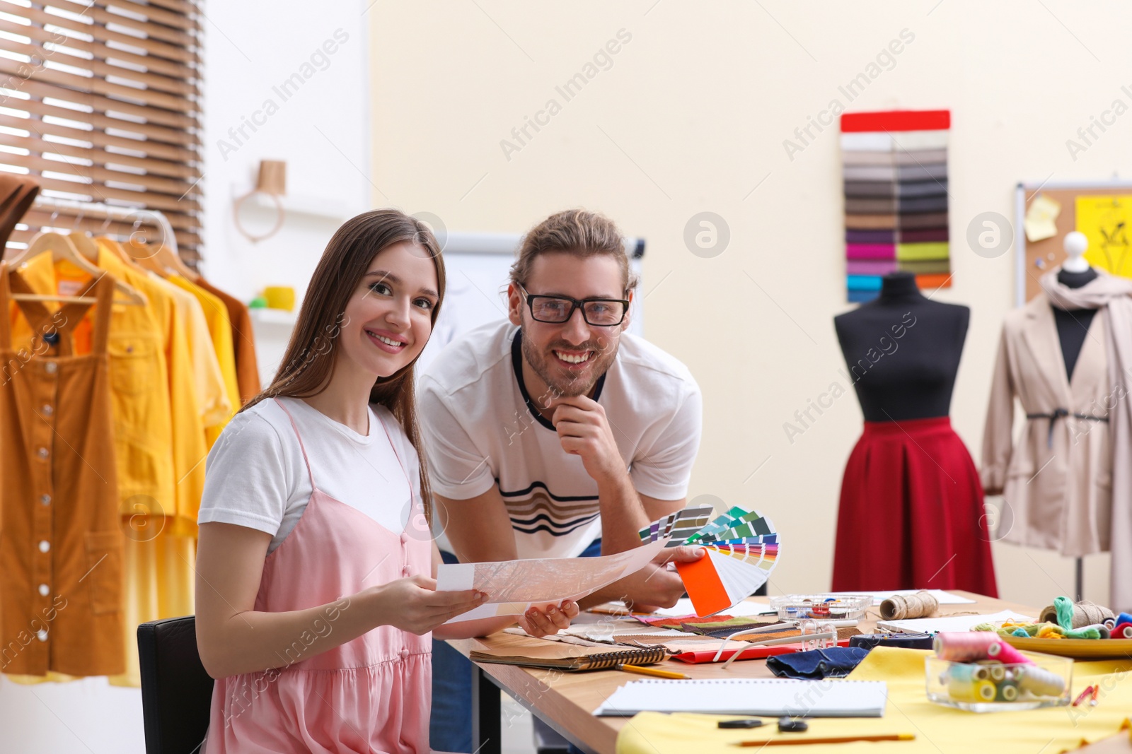 Photo of Fashion designers creating new clothes in studio