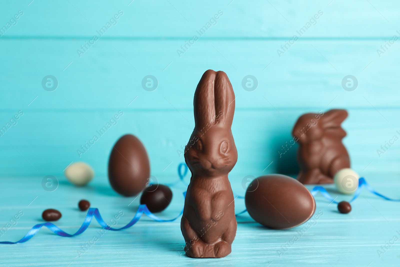 Photo of Composition with chocolate Easter eggs and bunny on table