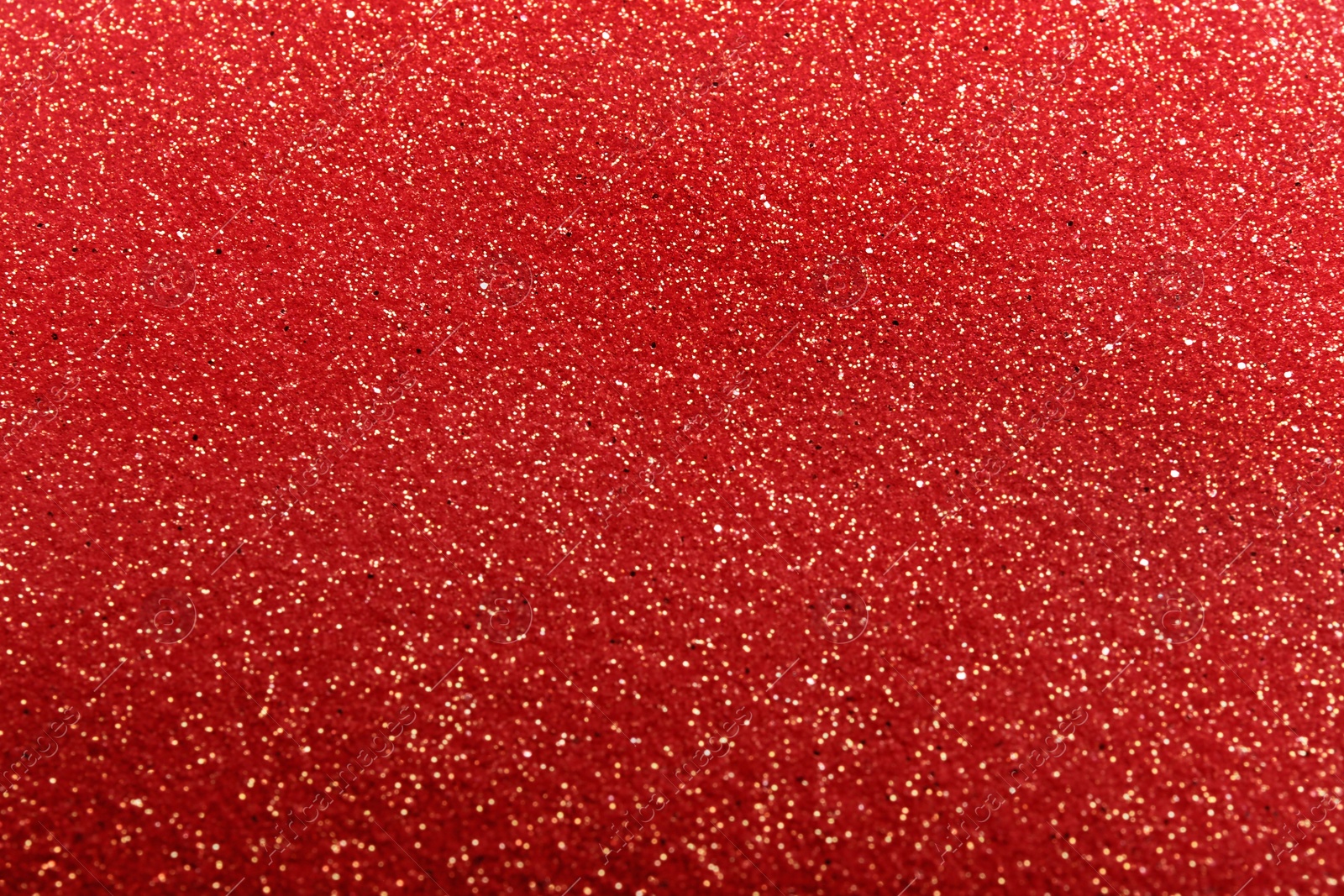 Photo of Closeup view of sparkling red glitter background