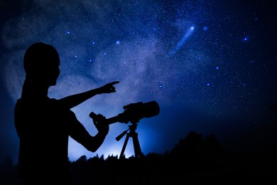 Image of Astronomer with telescope pointing at stars outdoors