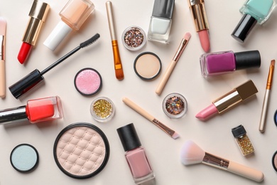 Flat lay composition with decorative cosmetics on color background