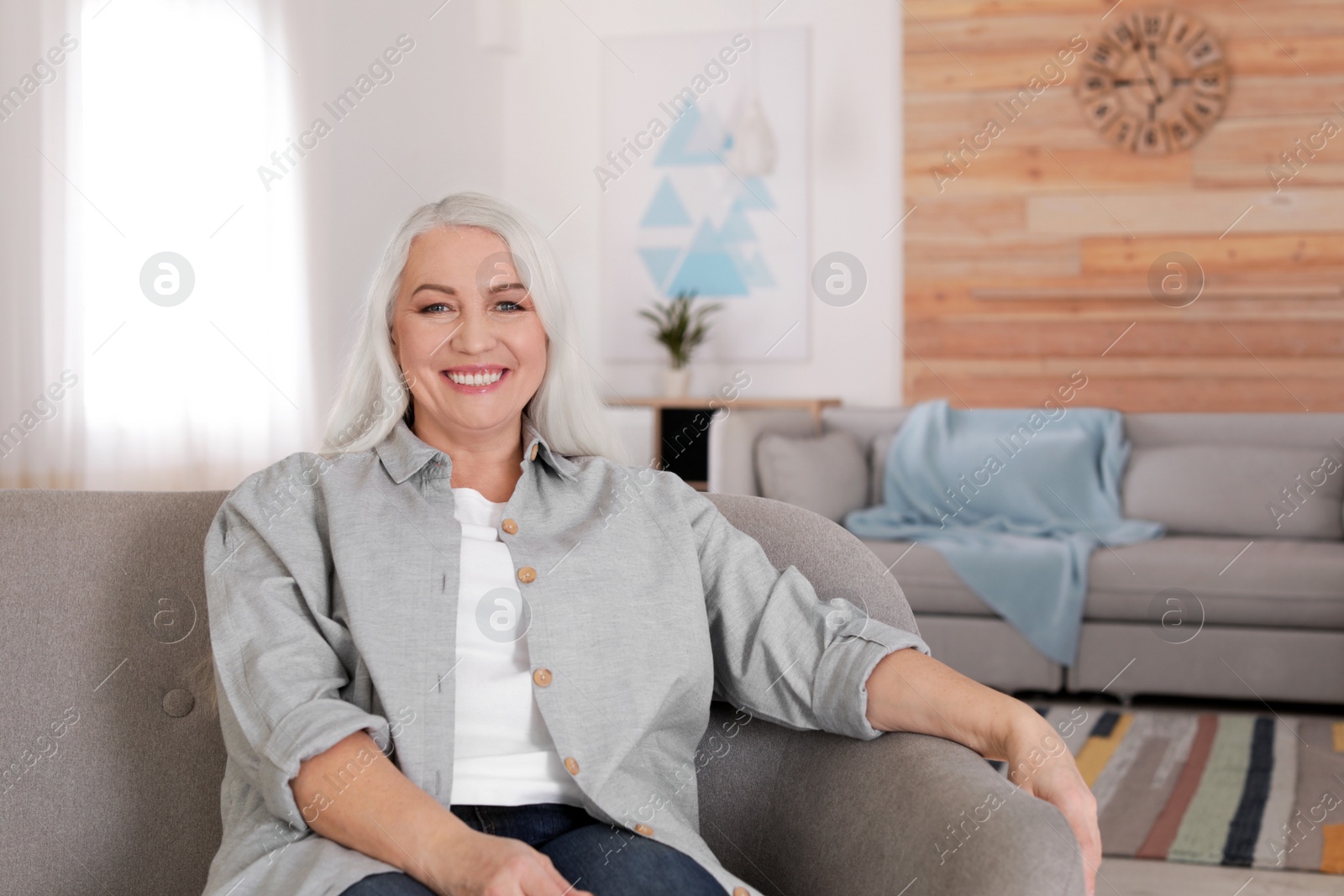 Photo of Portrait of mature woman in living room