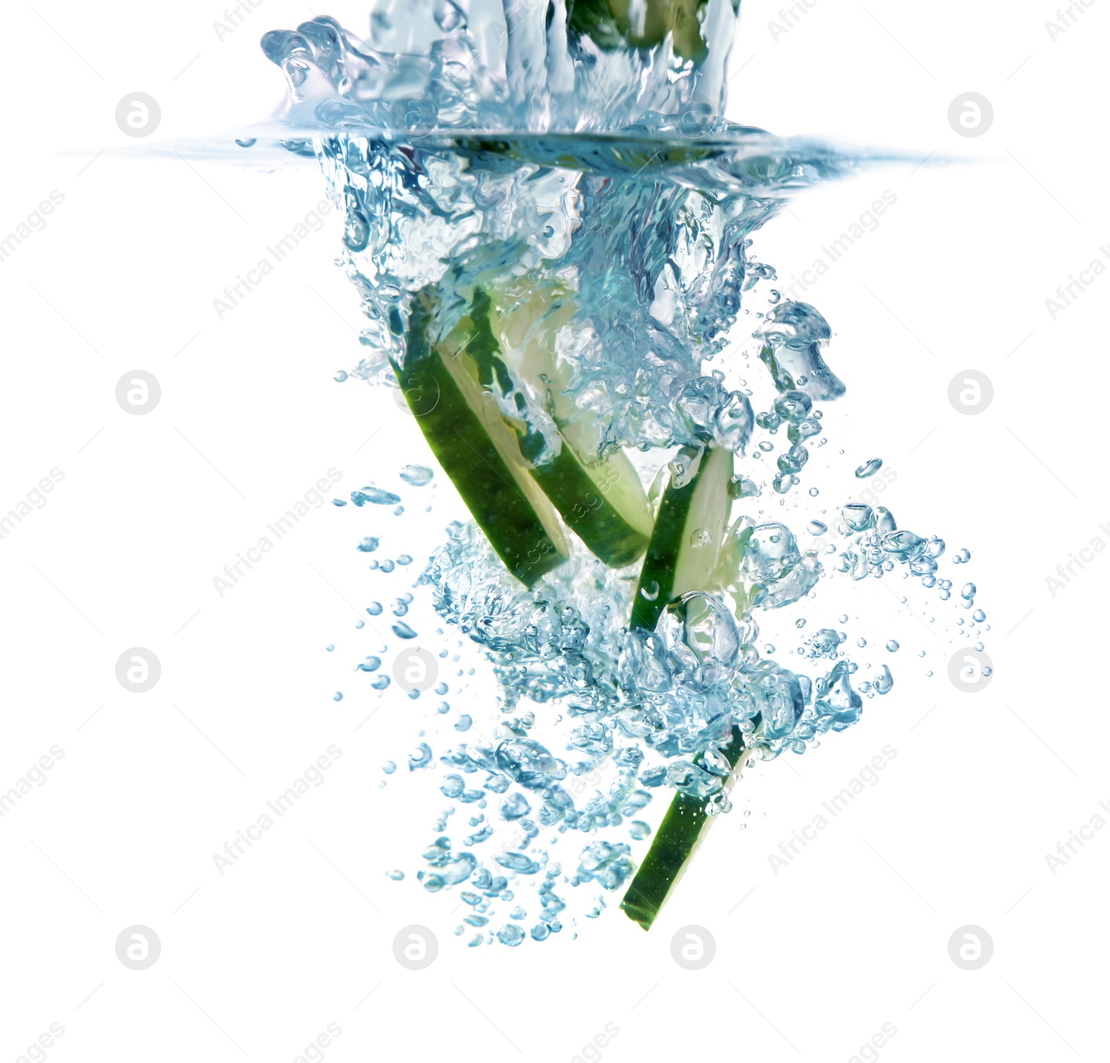 Photo of Slices of fresh cucumber falling into water on white background, closeup