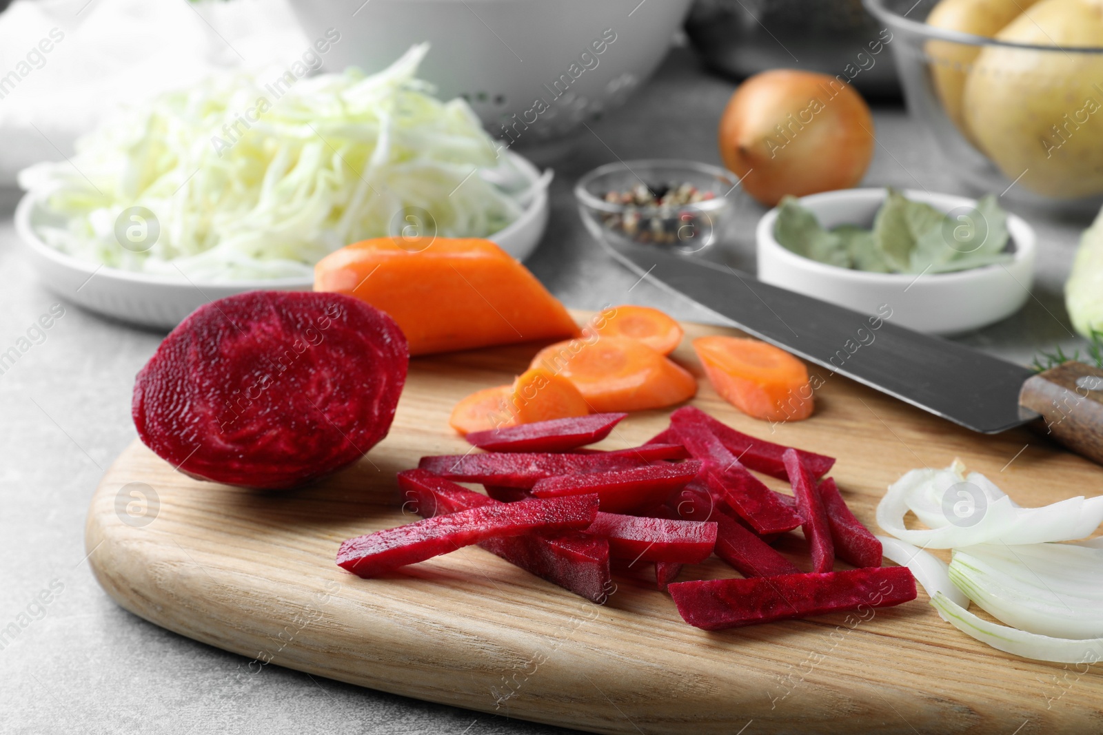 Photo of Fresh ingredients for borscht on light grey table, closeup