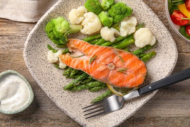 Photo of Healthy meal. Tasty grilled salmon with vegetables served on wooden table, flat lay