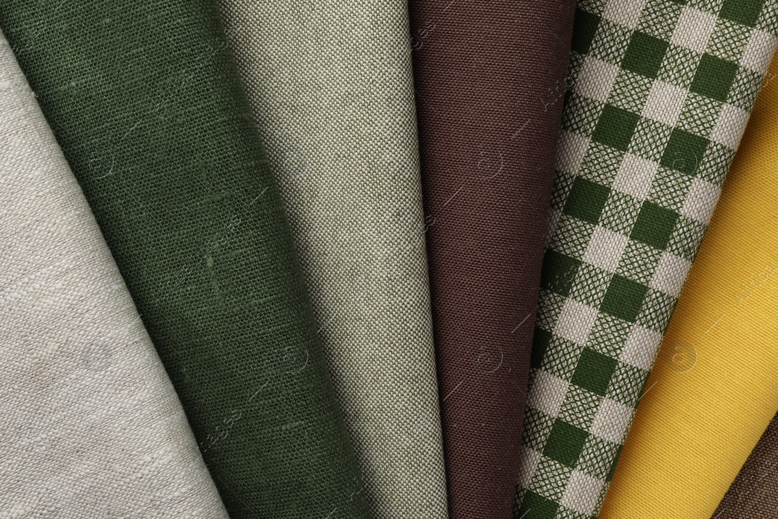 Photo of Many different fabrics as background, top view