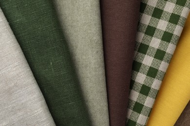 Photo of Many different fabrics as background, top view