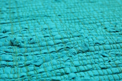 Color woven carpet texture as background, closeup