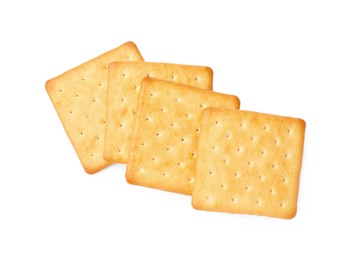 Many crispy crackers isolated on white, top view. Delicious snack