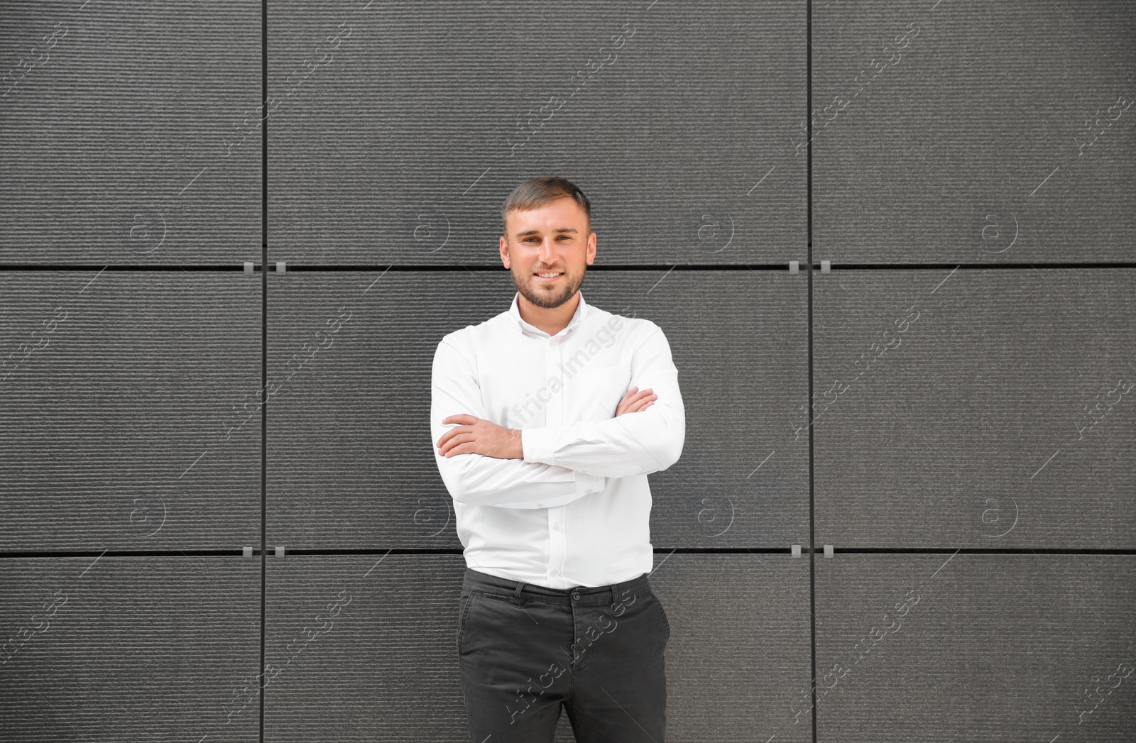 Photo of Portrait of handsome young man leaning to wall outdoors